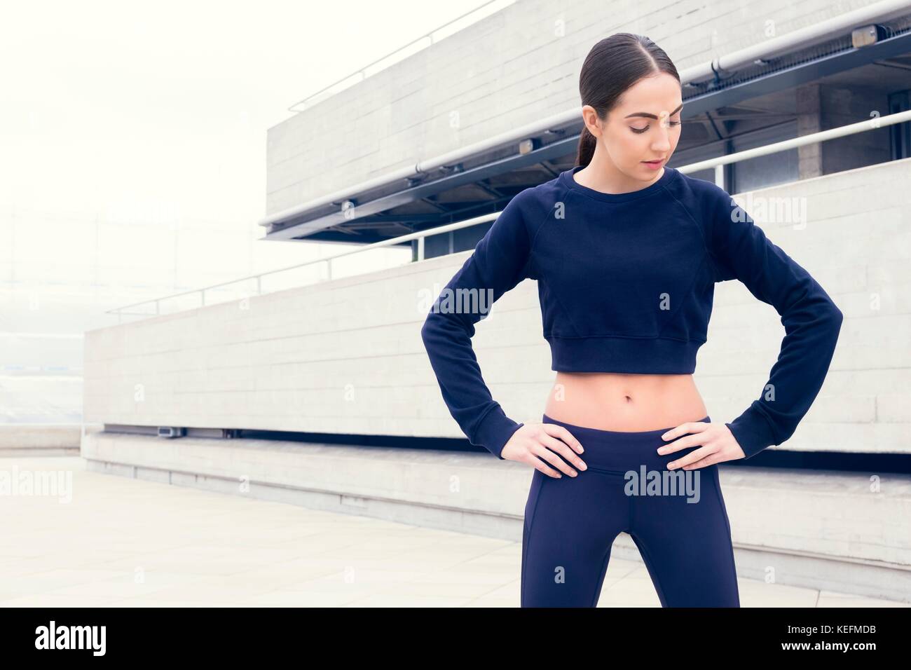 MODEL RELEASED. Junge Frau im Sport Kleidung auf den Hüften. Stockfoto