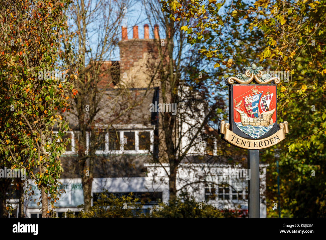 Stadt name Zeichen in der Form eines roten Schild mit einem goldenen galleon Crest in Tenterden, Kent, Südosten, England, Grossbritannien Stockfoto