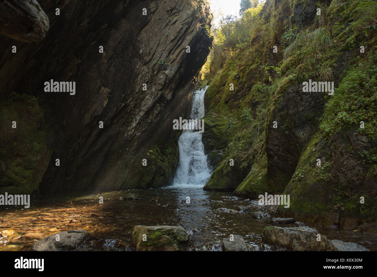 Kleinen versteckten Wasserfall im Wald, in der Felsspalte Stockfoto