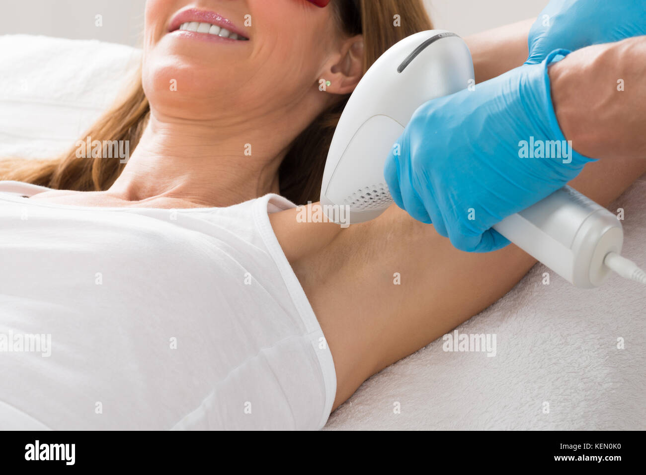 Reife Frau empfangen underarm Laser-Haarentfernung Behandlung Stockfoto
