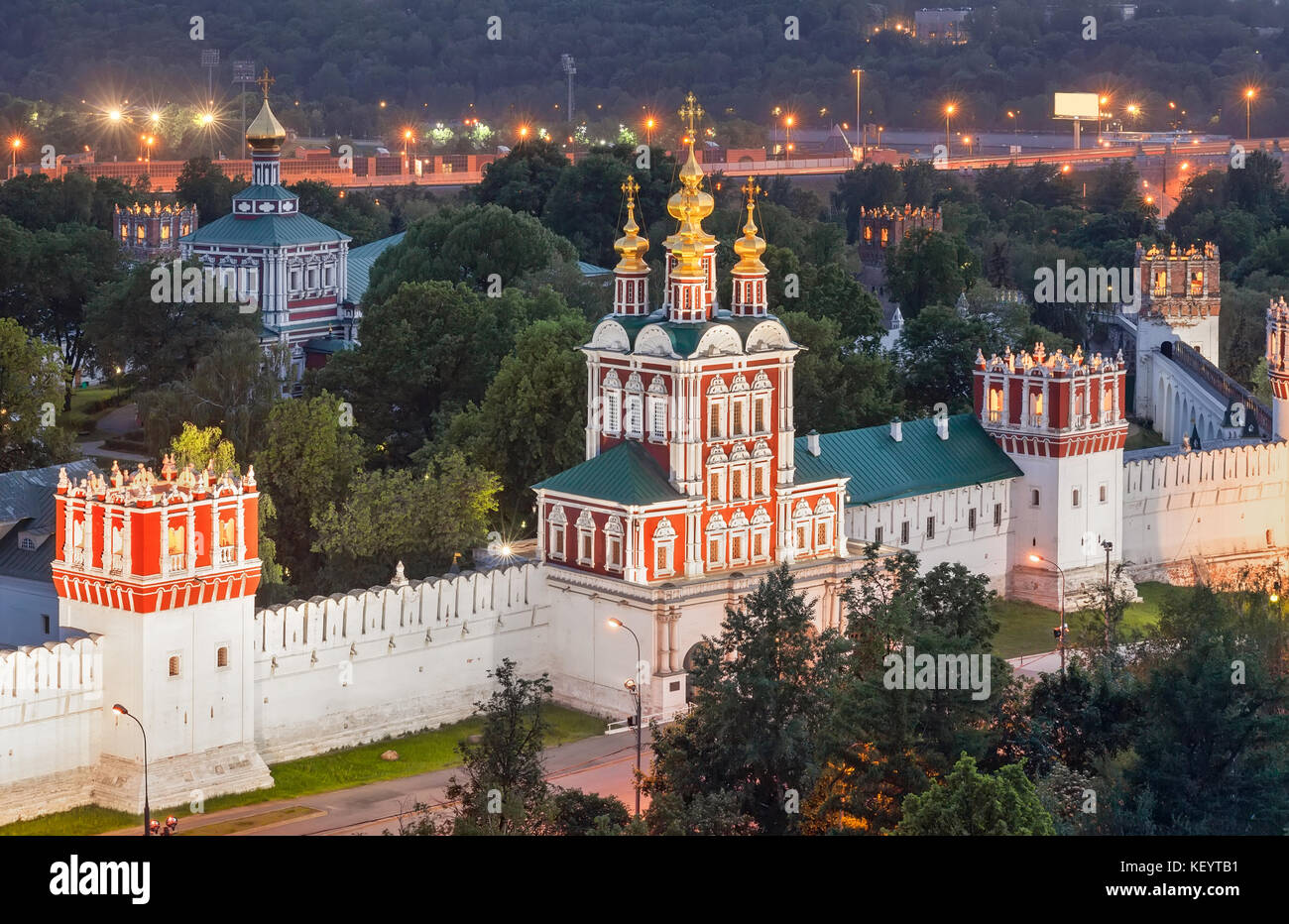 Russisch-orthodoxe Torhaus Kirche und ein Teil der Mauer mit Türmen des Neujungfrauenklosters am Abend. Moskau, Russland Stockfoto