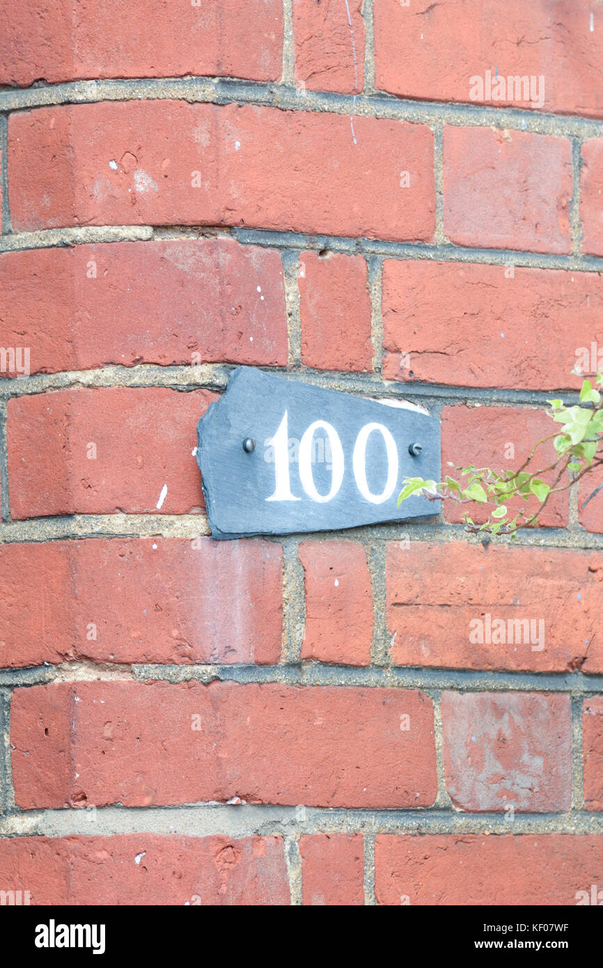 Haus Nummer 100 Schild an Wand Stockfoto