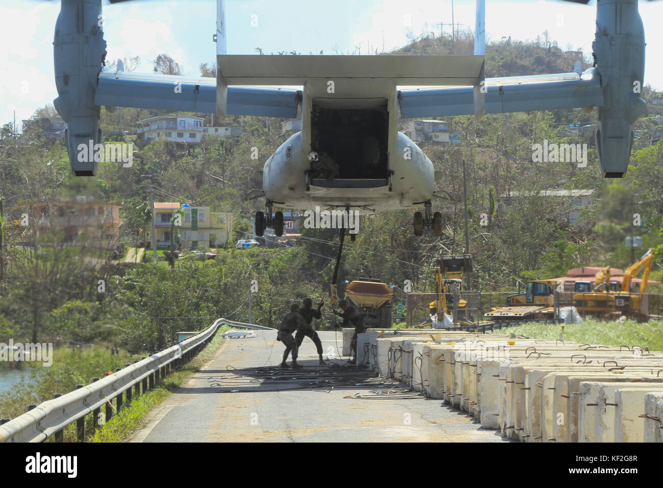 Us-marines befestigen Sie eine konkrete Sperre zu einem V-22 Osprey Flugzeug wie Sie arbeiten, die Schäden an der guajataca Damm in die Folgen des Hurrikans maria Oktober 3, 2017 in Puerto Rico. Stockfoto