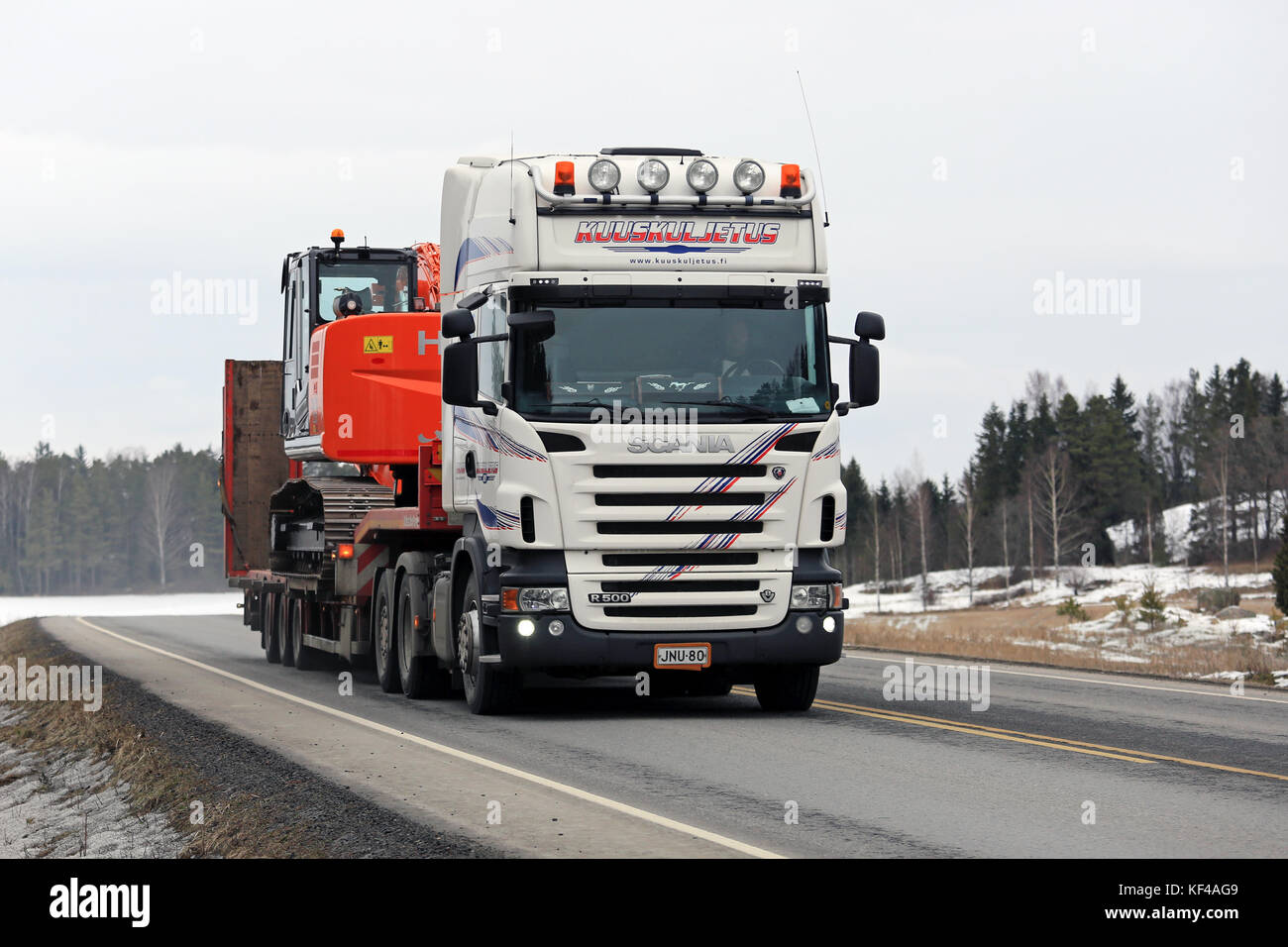 Salo, Finnland - 5. März 2016: Scania R 500 Hols neue Hitachi Zaxis 225 uslc Bagger entlang der Autobahn. Der zaxis 225 ist eine mittlere Hydraulikbagger. Stockfoto