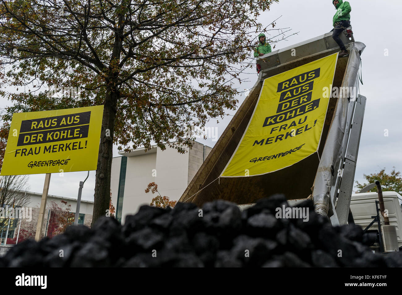 Berlin, Deutschland. Oktober 2017. Greenpeace-Aktivisten werden während einer Demonstration gesehen, wie sie einen LKW voller Kohle entladen haben. Greenpeace-Aktivisten haben vor dem Kanzleramt in Berlin 10 Tonnen Kohle abgeladen. Mit der Aktion wollen sie ihre Nachfrage nach einem schnellen Kohleabgang ausleihen. Die künftige Klima- und Energiepolitik steht im Mittelpunkt der Sondierungsgespräche der Union, der FDP in Berlin in Jamaika. Quelle: Markus Heine/SOPA/ZUMA Wire/Alamy Live News Stockfoto