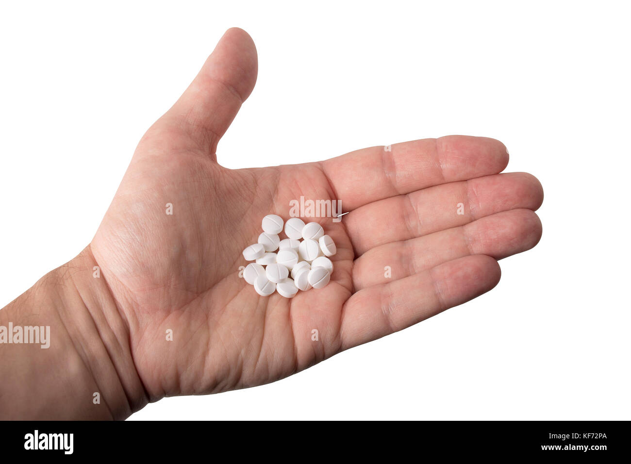 Eine kleine Handvoll von weißen Pillen auf einem weißen Hintergrund. Stockfoto