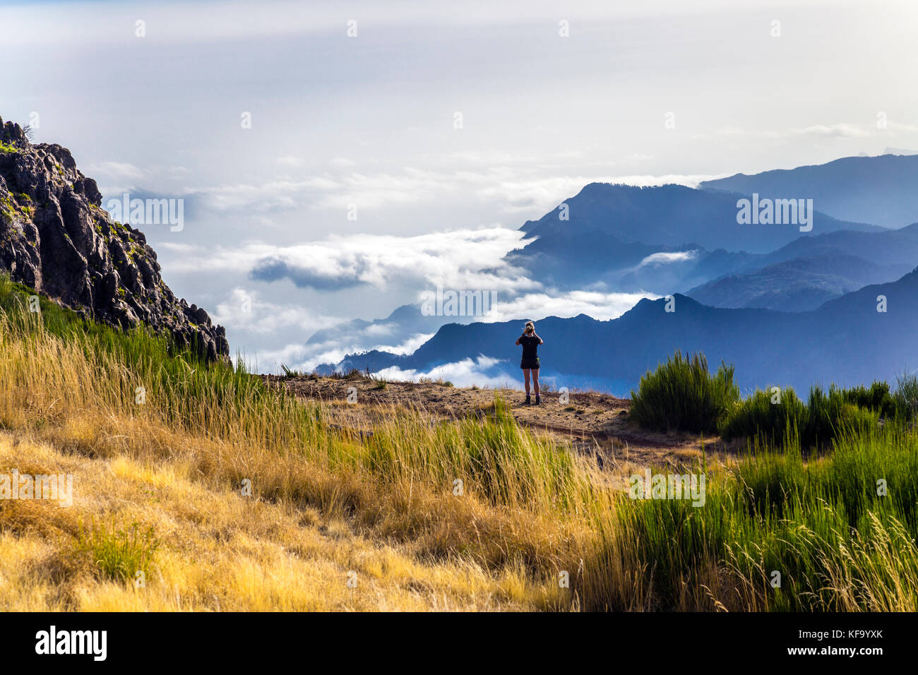 Wanderer, der auf dem Pico do Arieiro, Madeira, Portugal, von Wolken umhüllte Berge fotografiert Stockfoto