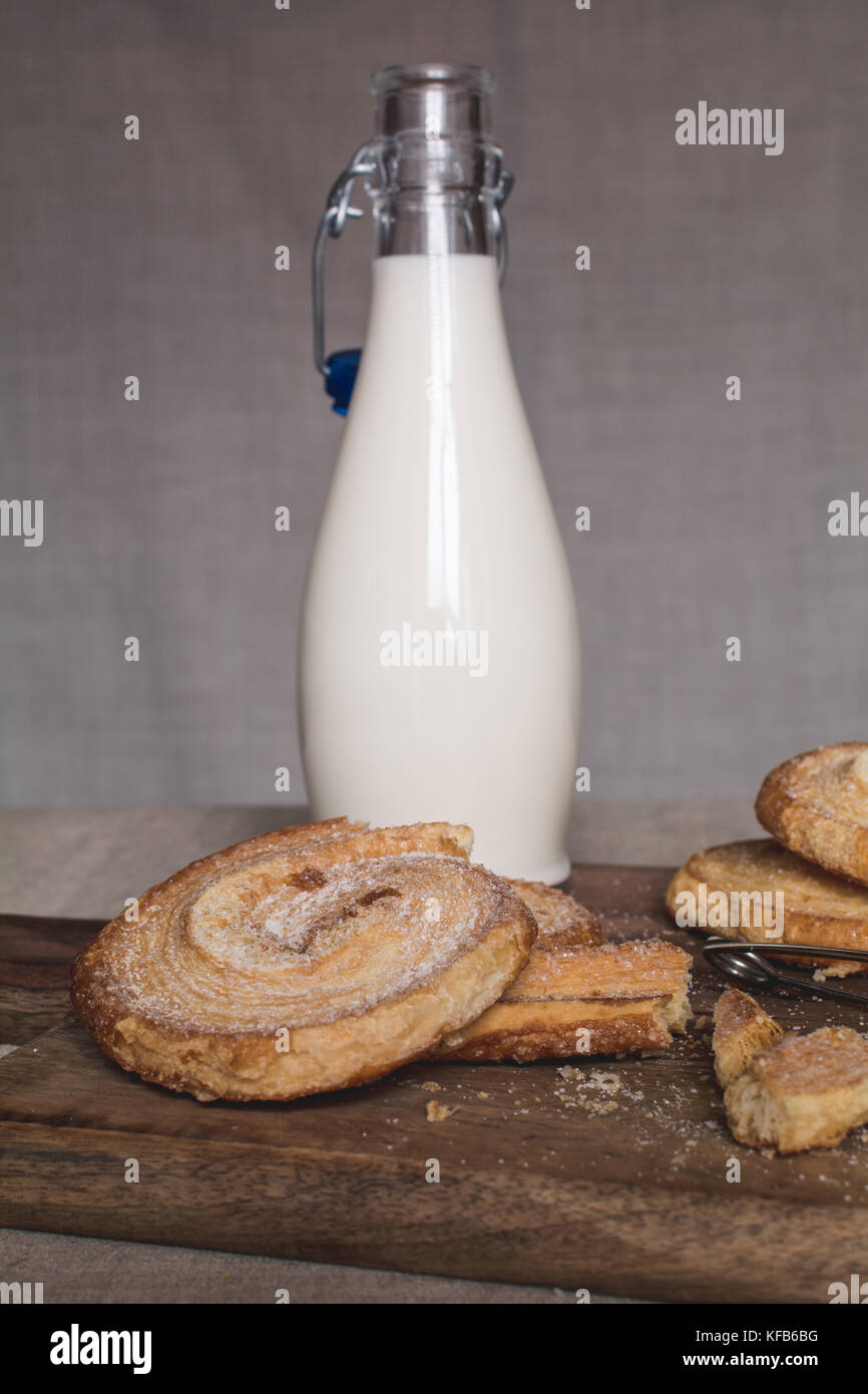 Milchflasche und süße Plätzchen mit Puderzucker Stockfoto