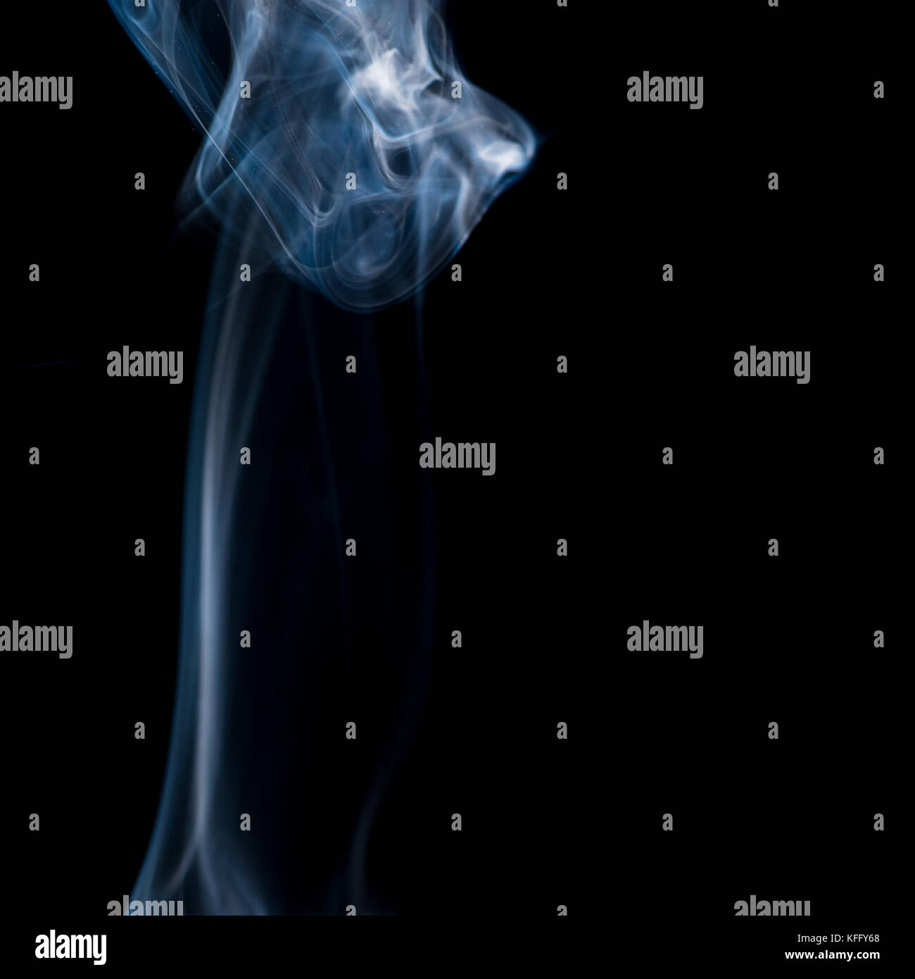 Steigende wirbelt der Rauch vor einem schwarzen Hintergrund. Stockfoto