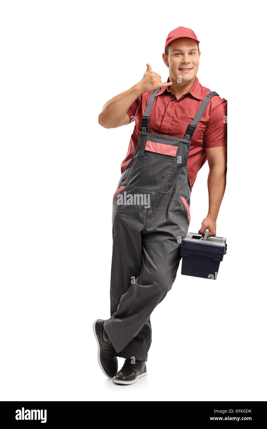 In voller Länge Porträt der Handwerker mit einer Toolbox einen Anruf machen mich unterzeichnen und lehnte sich gegen eine Wand auf weißem Hintergrund Stockfoto