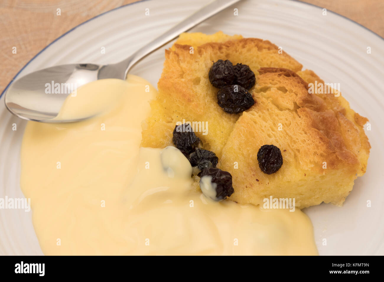 Eine Portion Brot und Butterpudding mit Pudding. Stockfoto