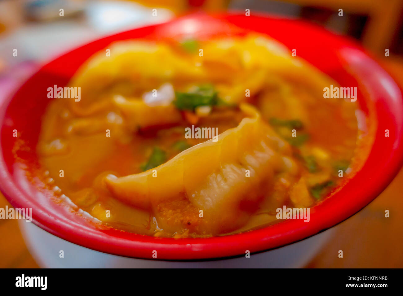 Nahaufnahme der gedämpfte Suppe von Momo in einer roten Schüssel serviert. Ein beliebtes Nepalesisches Essen, die auch im Val di Chiana, Bhutan, Tibet und Indien üblich ist Stockfoto