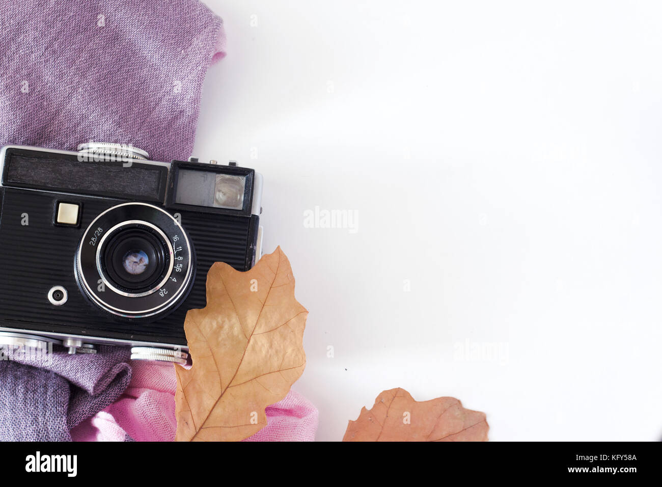 Retro Kamera und leeren alten sofortigen Papier Fotoalbum auf Holz Tisch mit Ahorn Blätter im Herbst Grenze Design - Konzept der Erinnerung und der Nostalgie in Stockfoto