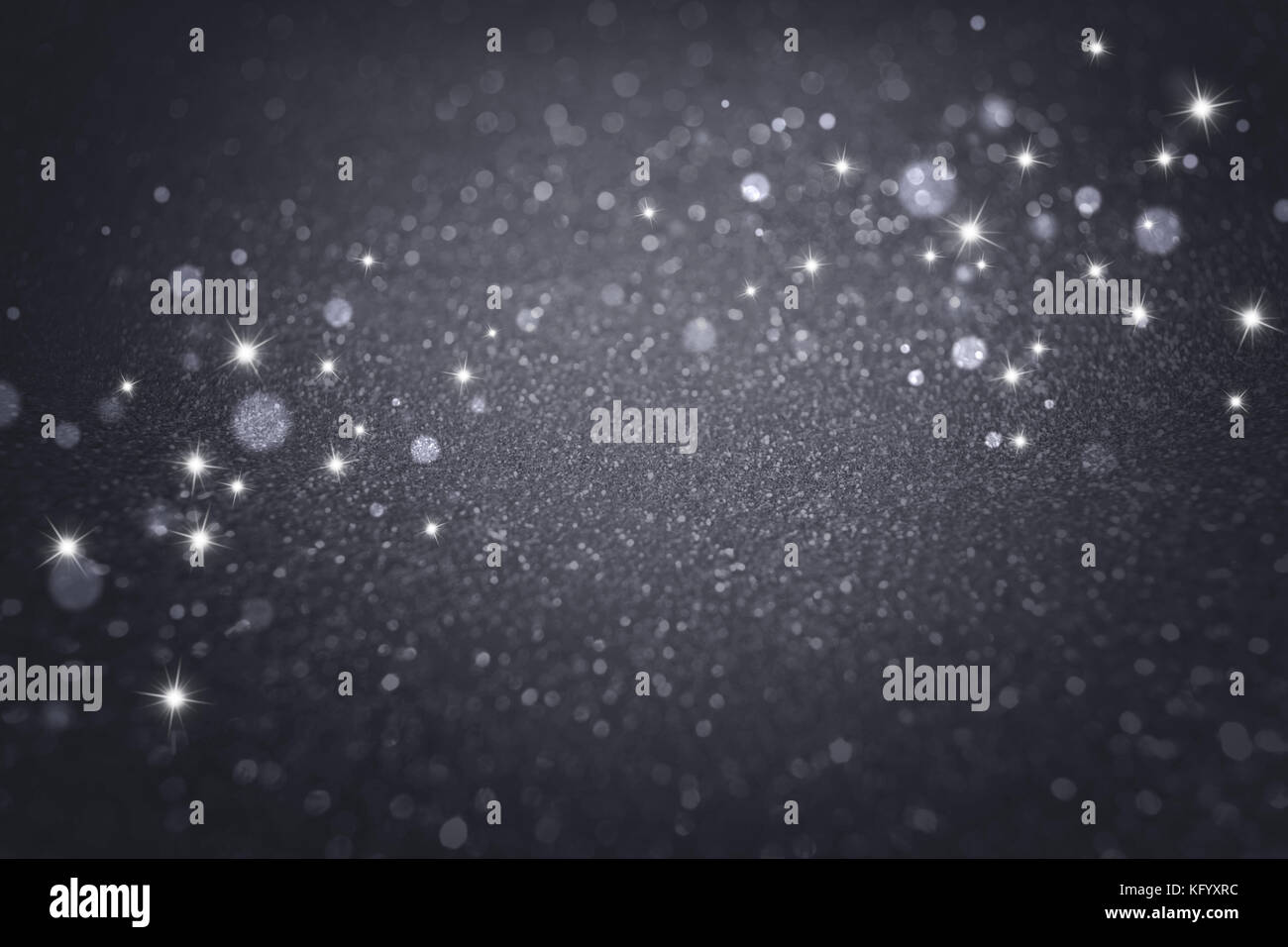 Helle Sterne auf einem glitzernden Defokussierten schwarzer Hintergrund Stockfoto