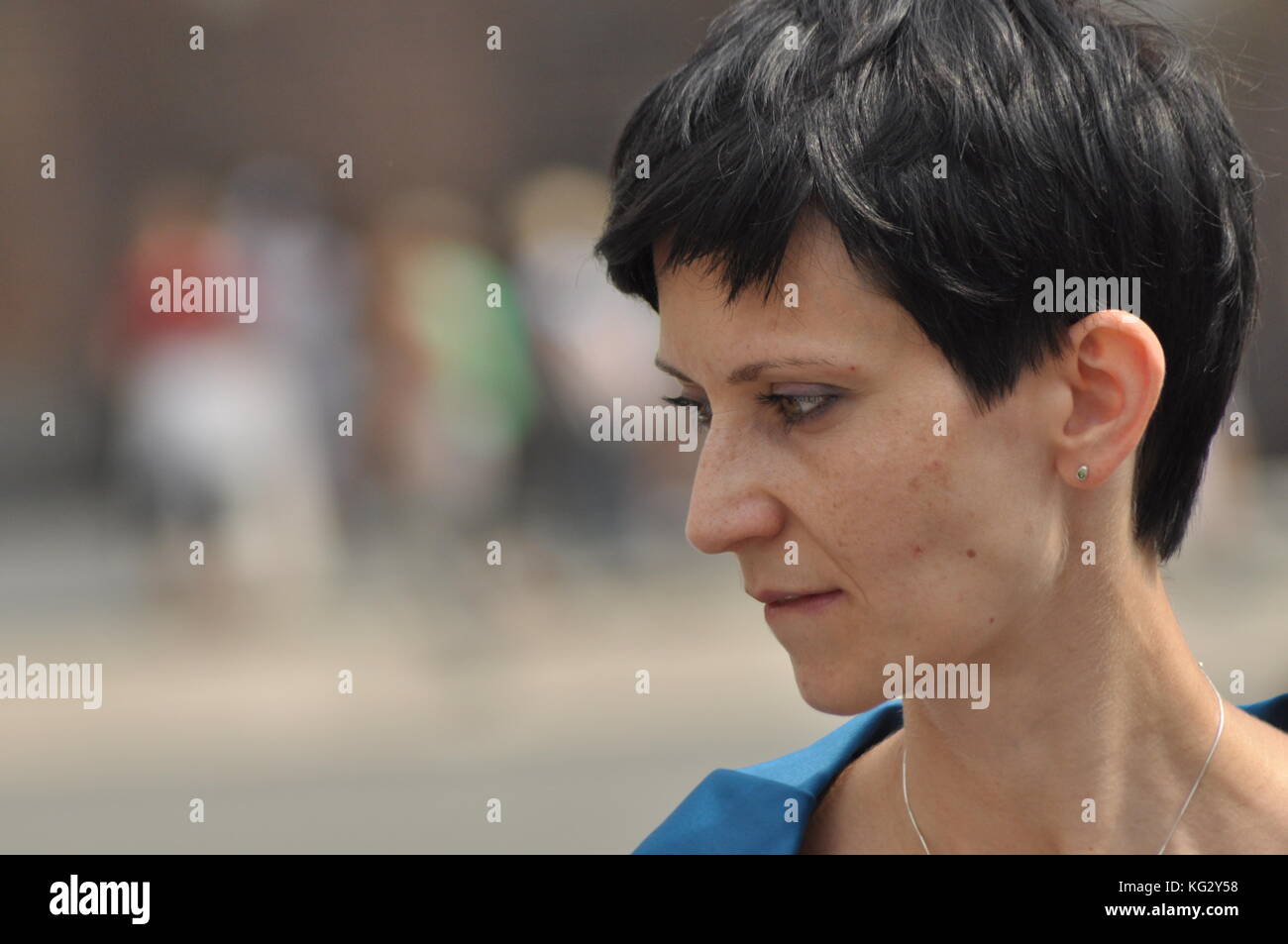 Die Frau unterhalten und nachdenklich. Mädchen mit Ohrringe. Lächeln und Zufriedenheit. Stockfoto