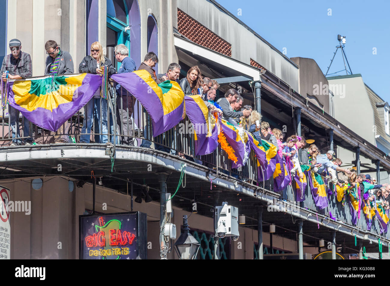Die Menschen werfen Beads und Feier vom Balkon während Mardi Gras in New Orleans, Louisiana Stockfoto