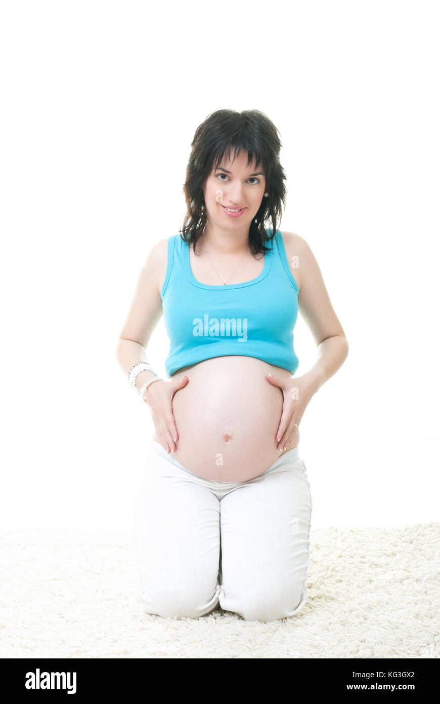 Die schwangere Frau den Bauch mit Ihren Händen berühren Stockfoto