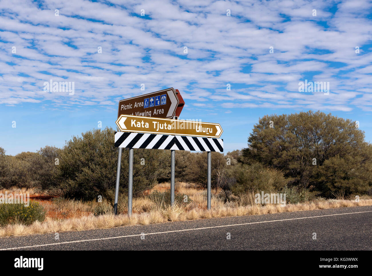 Straßenschilder nach Kata Tjuta und Kata Tjuta Uluru im Uluṟu-Kata Tjuṯa National Park, Northern Territory, Australien Stockfoto