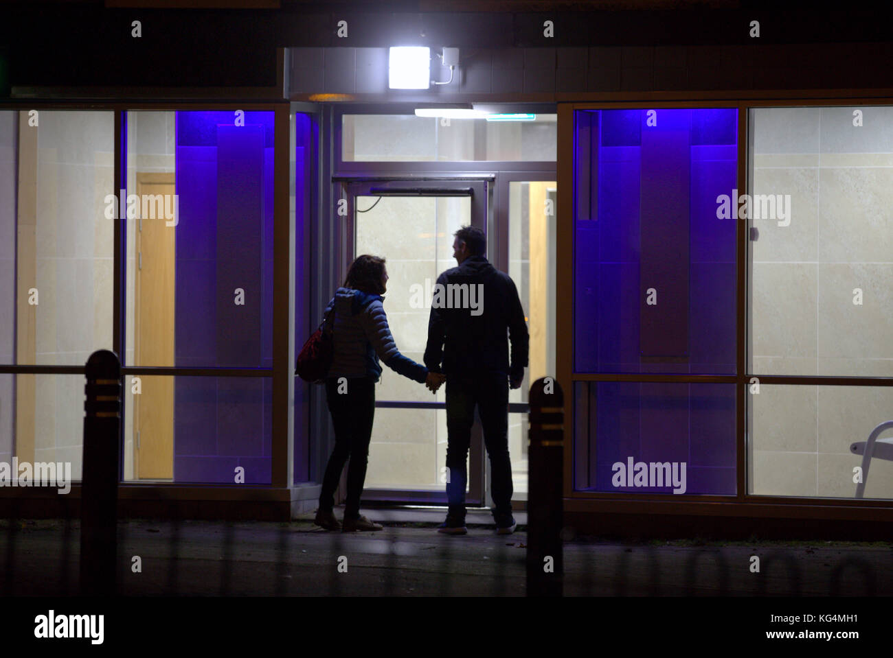 Bis spät in die Nacht Paar fremden Mann und Frau an der Außenseite flache Tür silhouette Gefahr gesehen von hinten Stockfoto