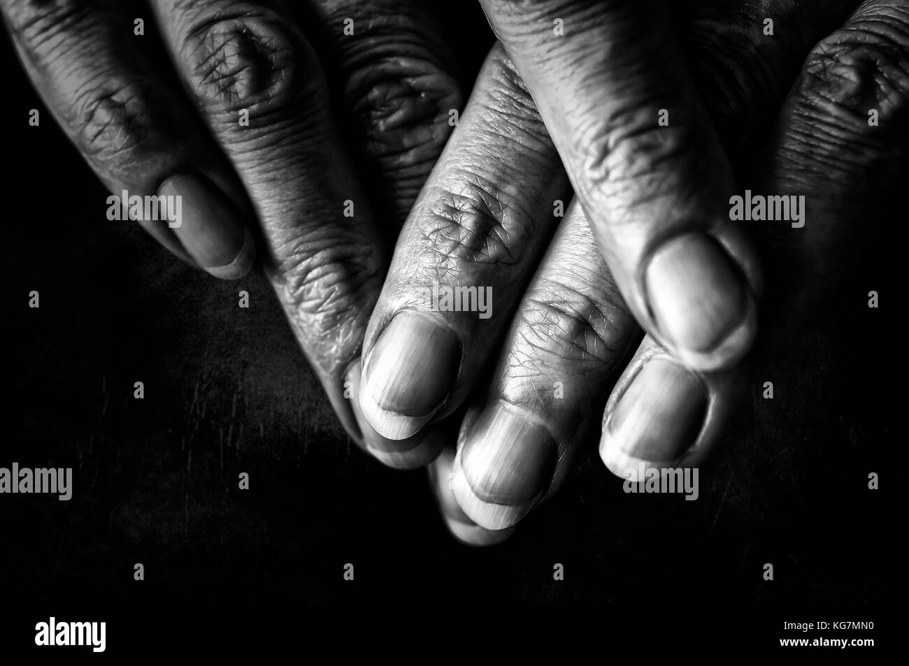 Schwarz-weiß Foto von älteren Frau Finger auf schwarzem Hintergrund Stockfoto