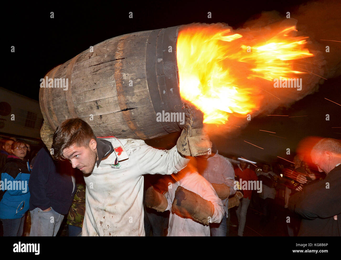 Die Teilnehmer laufen mit einer brennenden Fass im Teer bei der jährlichen Ottery St Mary tar barrel Festival in Devon getränkt, uk Credit: finnbarr Webster/alamy leben Nachrichten Stockfoto