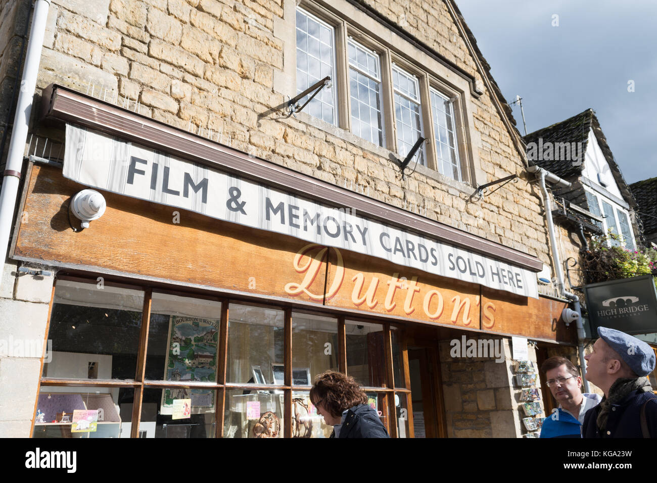 Touristen und Fotografie - das Schild „Film and Memory Cards Sold Here“ im beliebten Touristenort Cotswold in Bourton on the Water, England, Großbritannien Stockfoto