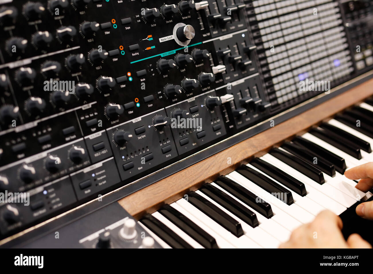 Ein Musiker am Keyboard des modernen analogen Synthesizers. Selektiver Fokus. Stockfoto