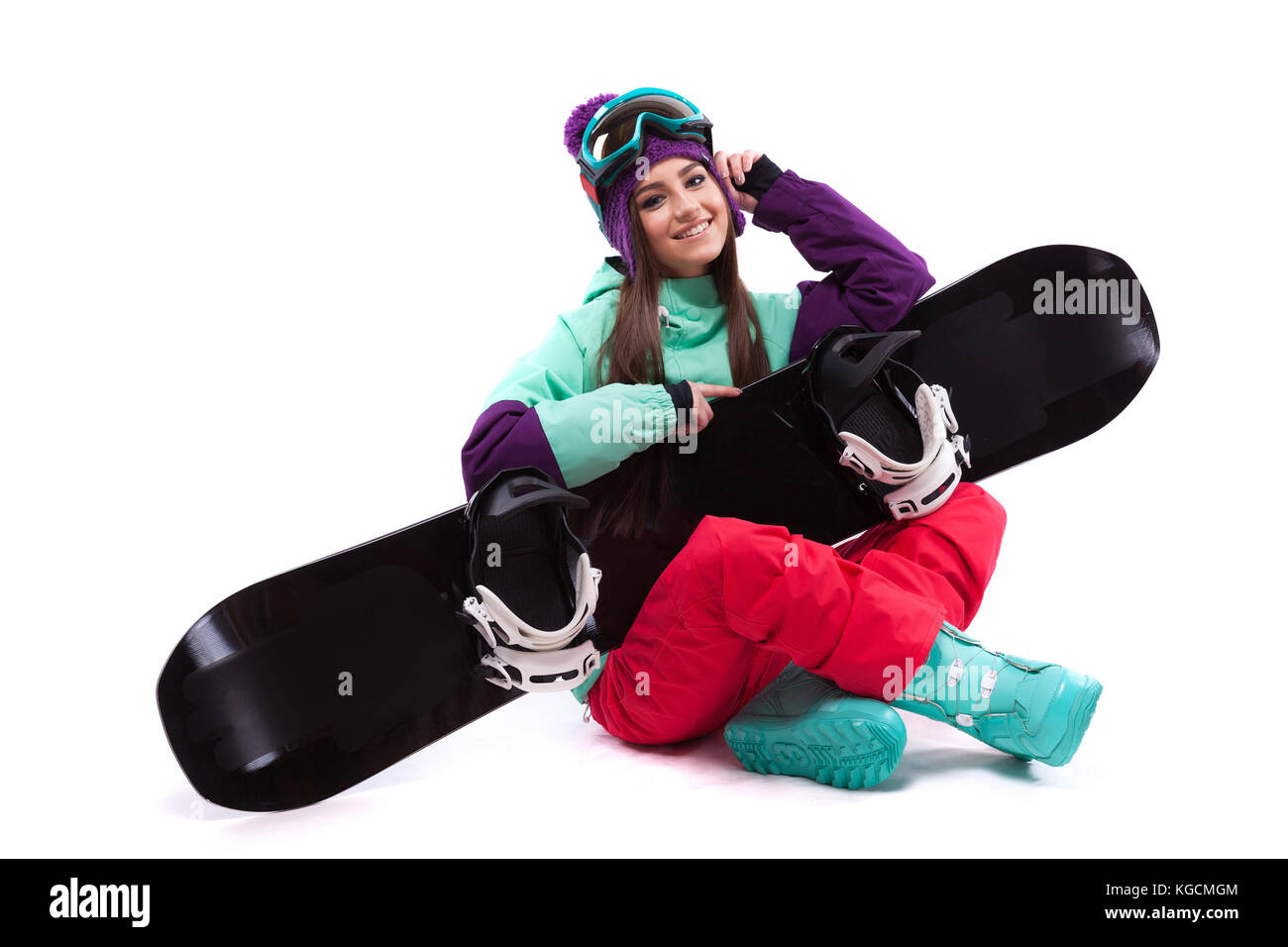 Beauty Mädchen sitzen mit gekreuzten Beinen mit Snowboard auf Knie Stockfoto