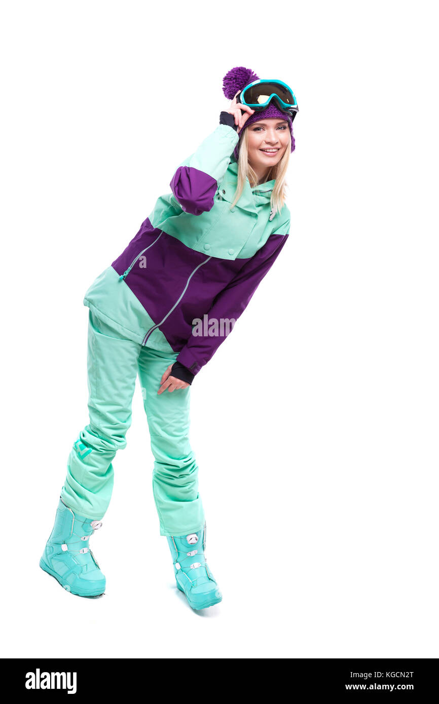 Junge schöne Frau in lila Skianzug und Blau snow Boots Stockfoto