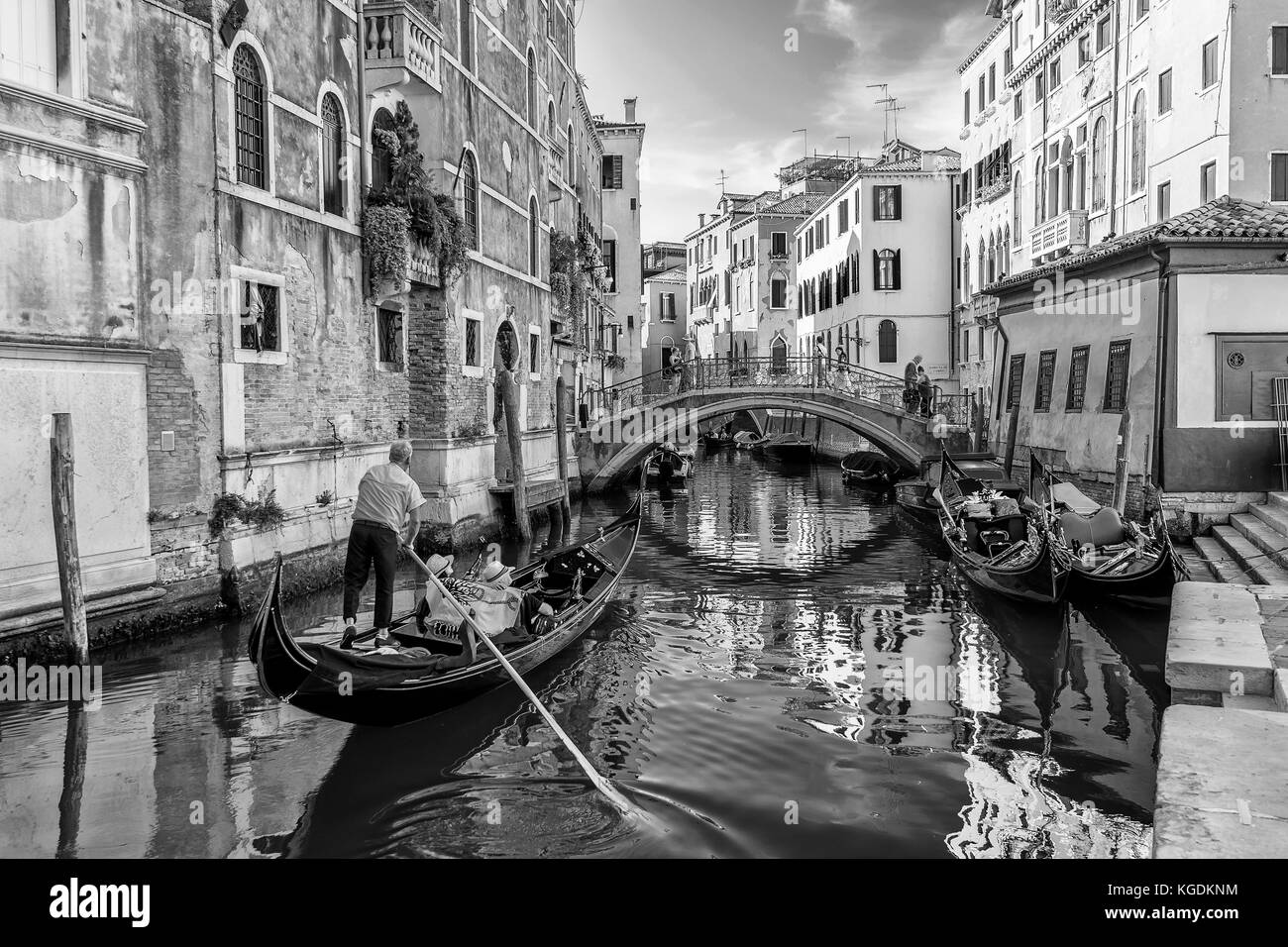 Schöner Blick auf eine typisch venetianische Gondel in einem zentralen Kanal, Venedig, Italien, in Schwarz-Weiß Stockfoto