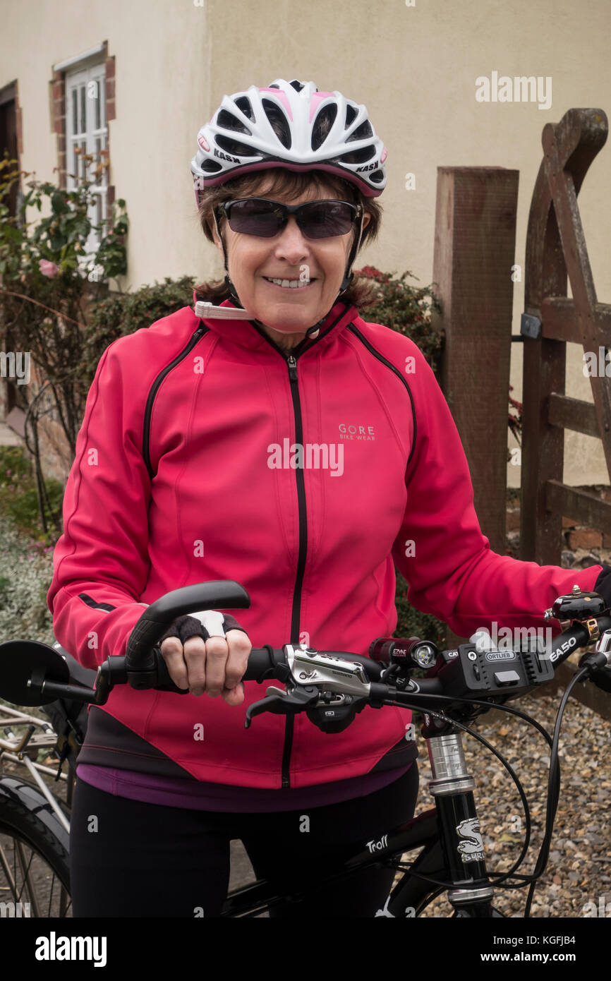 65 Jahre alte weibliche Radfahrer, für eine Fahrt mit dem Fahrrad bereit Stockfoto
