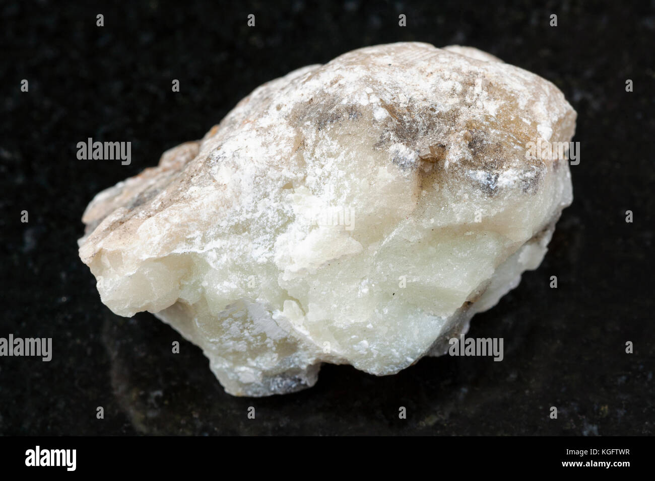 Makroaufnahmen von natürlichen Mineralgestein Muster - grobe Talkum Stein auf dunklem Granit Hintergrund von Irkutsk Region Stockfoto
