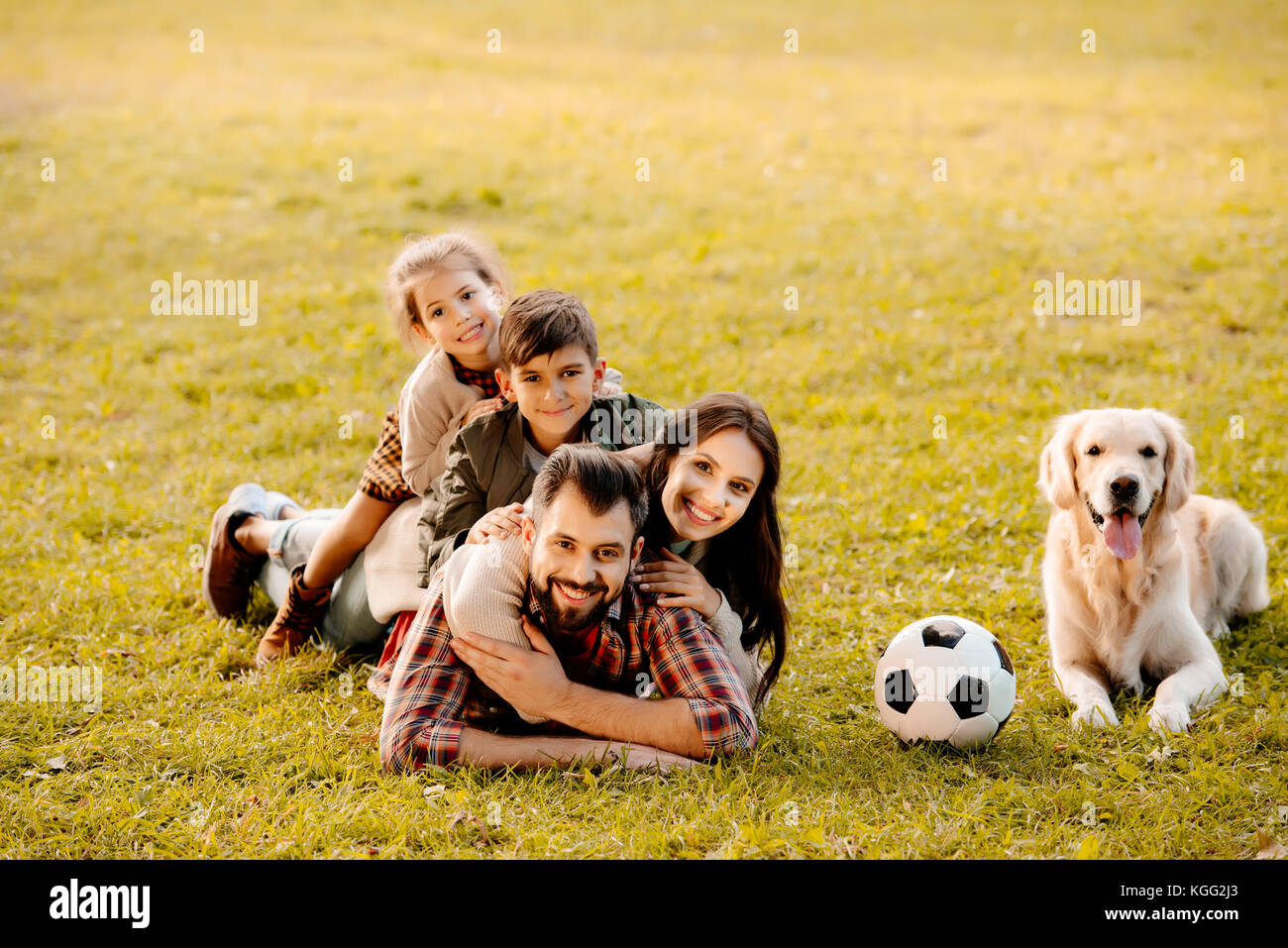 Familie liegen in Haufen auf Gras Stockfoto