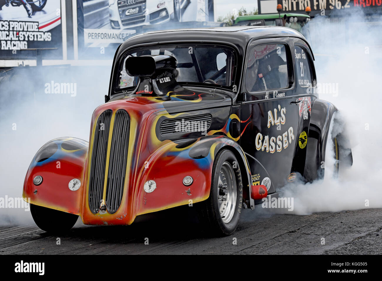 Alan O Connor burn-out seine Al's Gasser Outlaw Anglia in Santa Pod Raceway Stockfoto