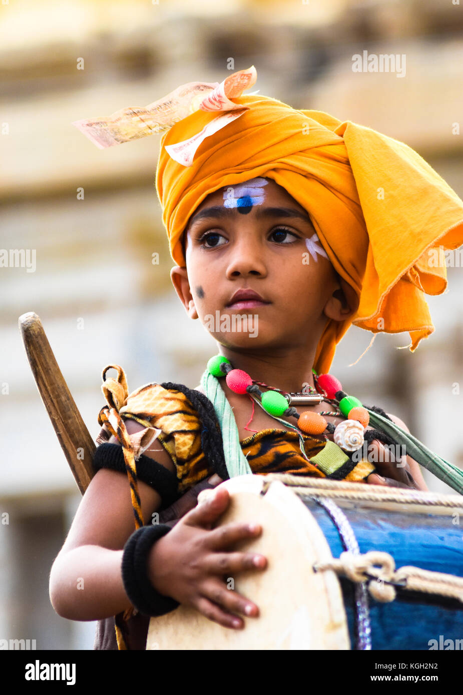 Kleiner Junge, der auf einem indischen Festival religiöser Musik in Hampi, Karnataka, die Trommel spielt Stockfoto