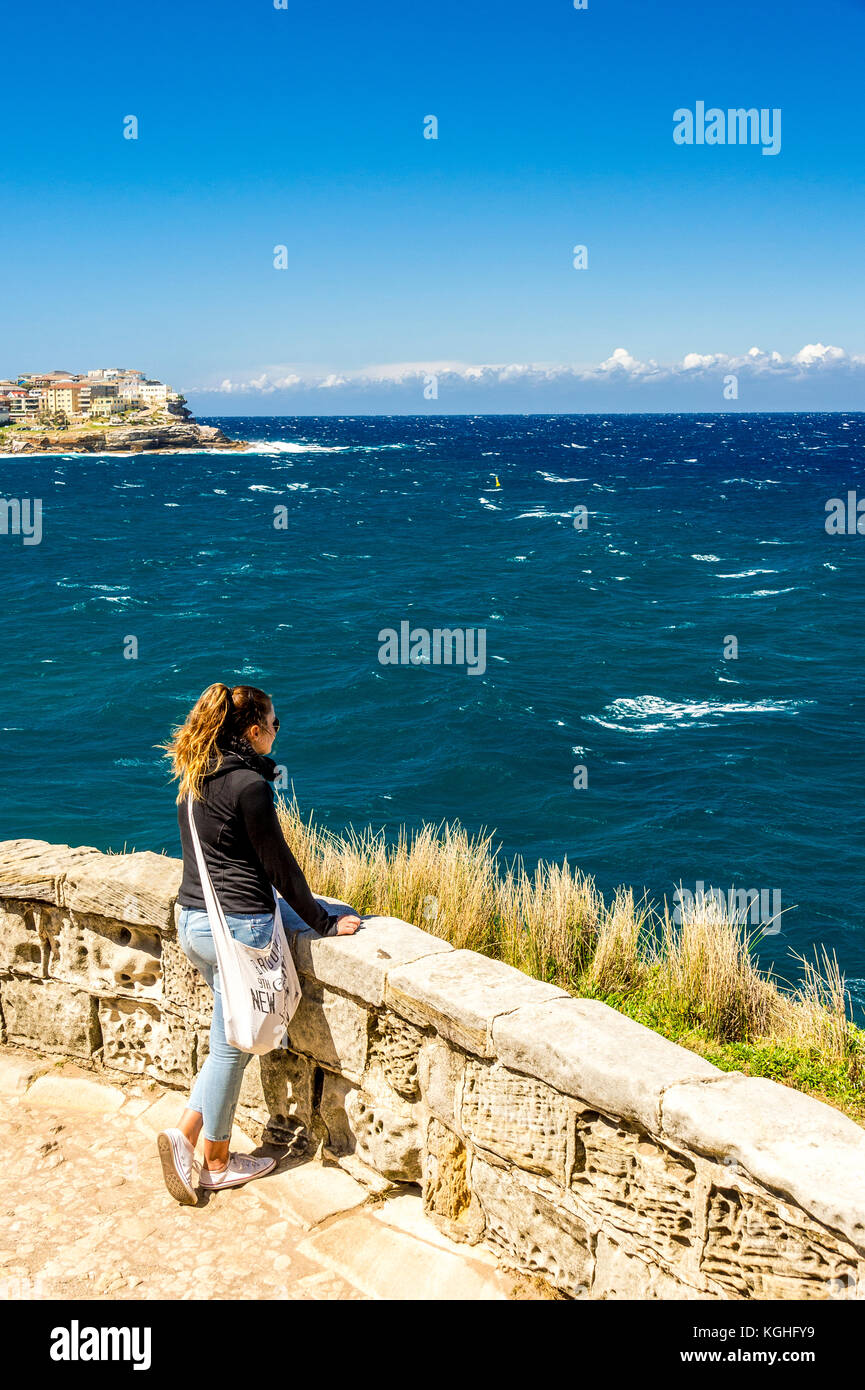 Eine Frau schaut auf das Meer bei Mackenzie's Point in der Nähe von Bondi Beach in Sydney, NSW, Australien Stockfoto
