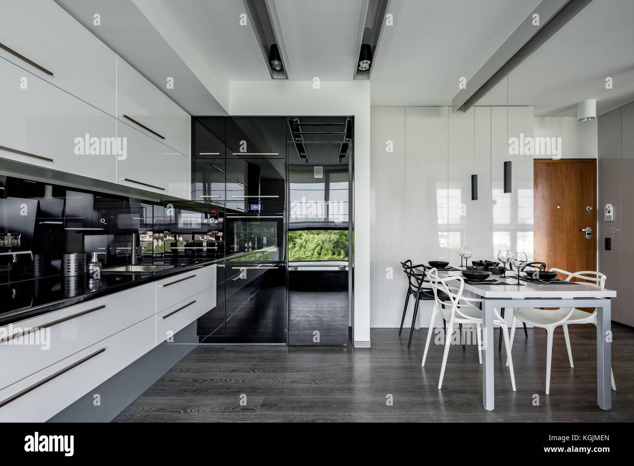 Moderne Küche in schwarz-weiß mit Esstisch Stockfoto