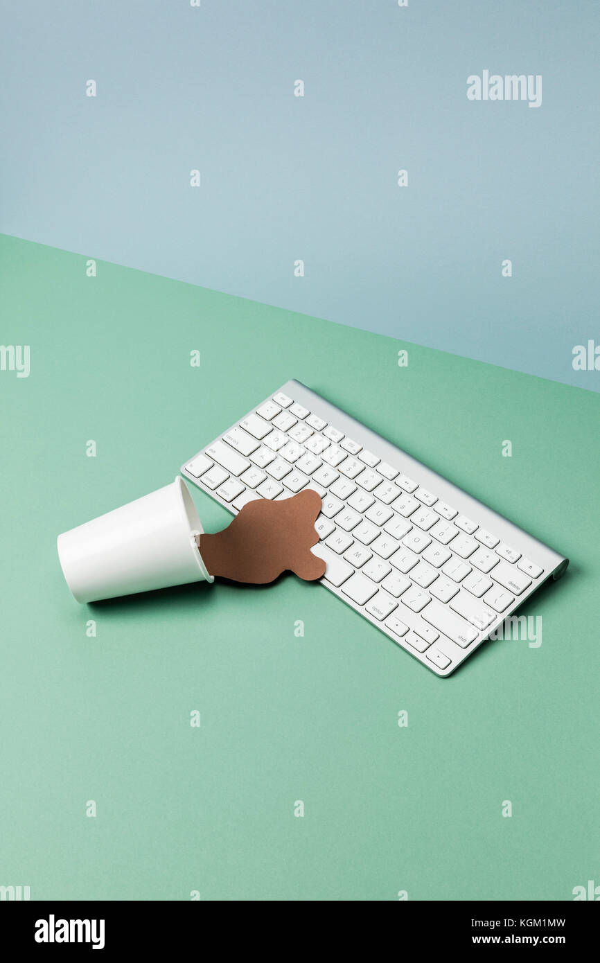 Verschüttete Kaffee Kunst auf Wireless Keyboard am grünen Tisch Stockfoto