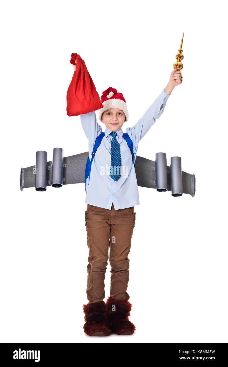 Junge Santa Claus mit einem Jetpack auf dem Rücken hält Geschenke für Weihnachten Stockfoto