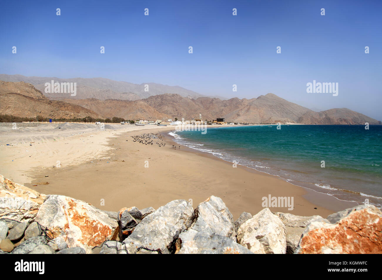 Ansicht auf einen schmutzigen Strand in Oman, sonnig warmen Tag, al Hajar Berge im Hintergrund, kein Volk Stockfoto