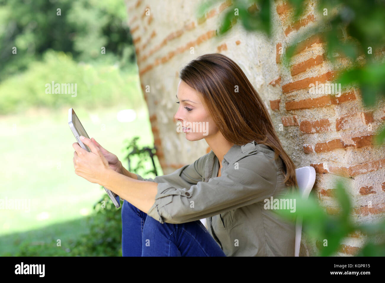 Mädchen auf Internet im Land Home Garten verbunden Stockfoto