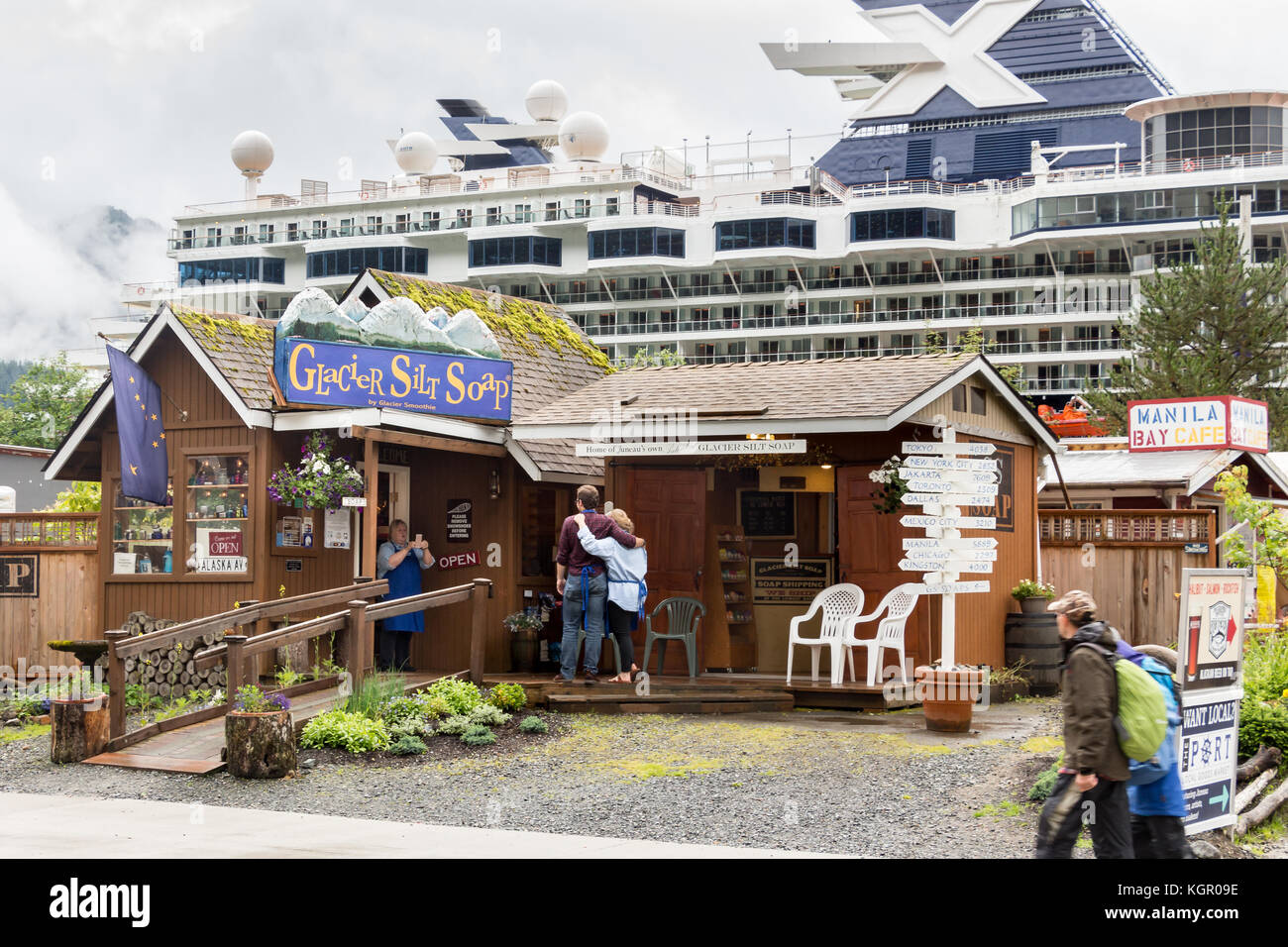 Juneau, Alaska, USA - 28. Juli 2017: Mitarbeiter des Glacier Silt Seifenladens machen an einem regnerischen Tag Fotos mit einem Handy vor dem Laden. Stockfoto