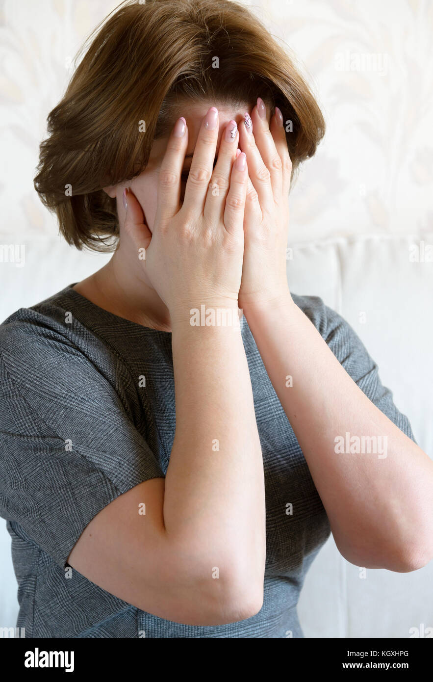 Frau, die ihr Gesicht mit der Hand. Depression Stockfoto