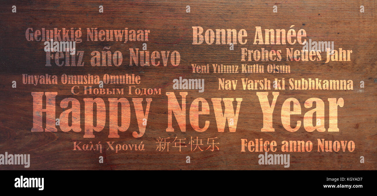 Ein frohes neues Jahr wünschen in vielen Sprachen auf Holz- Hintergrund Stockfoto