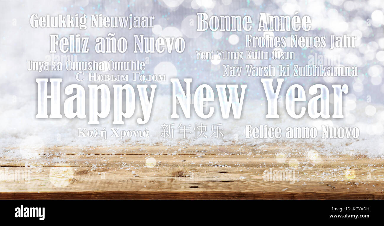 Ein frohes neues Jahr wünschen in vielen Sprachen auf verschneiten Hintergrund Stockfoto