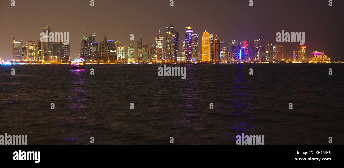 Doha, Katar - November 11, 2017: Nacht Blick auf die Türme der Stadt während der diplomatischen Krise, mit riesigen Bilder der Emir auf einigen. Stockfoto