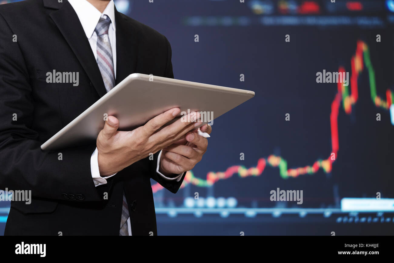 Geschäftsmanns, der auf digitalen Tablet mit dem Aufbringen des Finanz-, Börsen-, grafik hintergrund. Investitionen in die Börse und forex trading Konzept Stockfoto