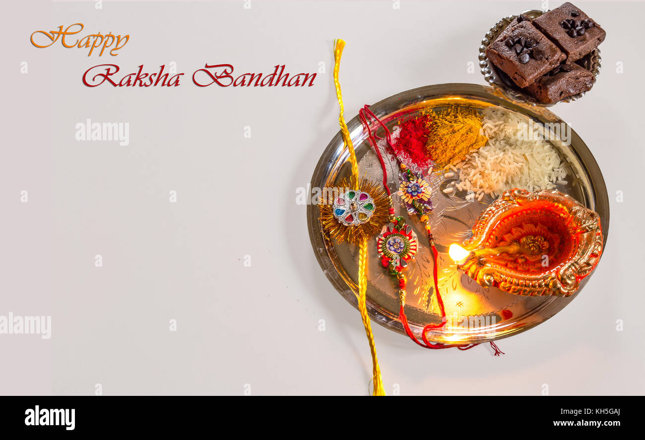 Raksha Bandhan indischen Hindu festival Hintergrund Inhalte mit rakhi, Ton öl Lampe, Reis Spezialitäten und kumkum Pulver. Stockfoto