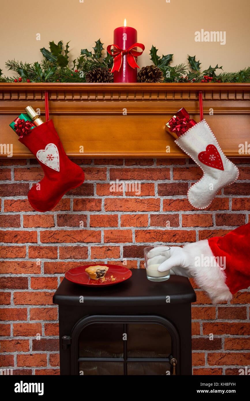 Strümpfe über einen Kamin an Heiligabend hängen mit Santa, ein Glas Milch, die für ihn hinterlassen wurden. Stockfoto