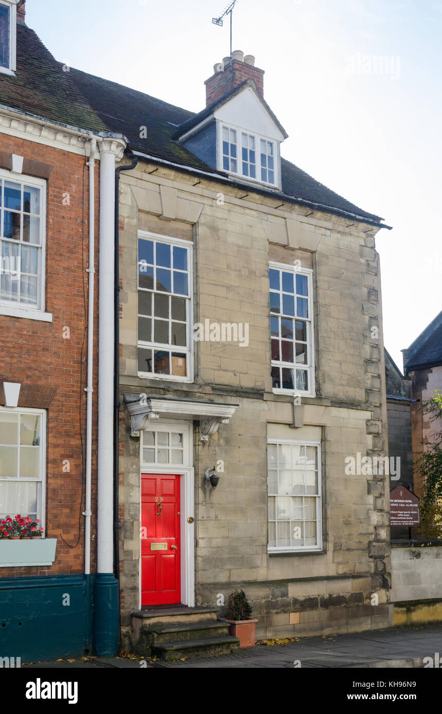 Smart Stone Town House in der High Street, Warwick, Warwickshire mit leuchtend roten Tür Stockfoto